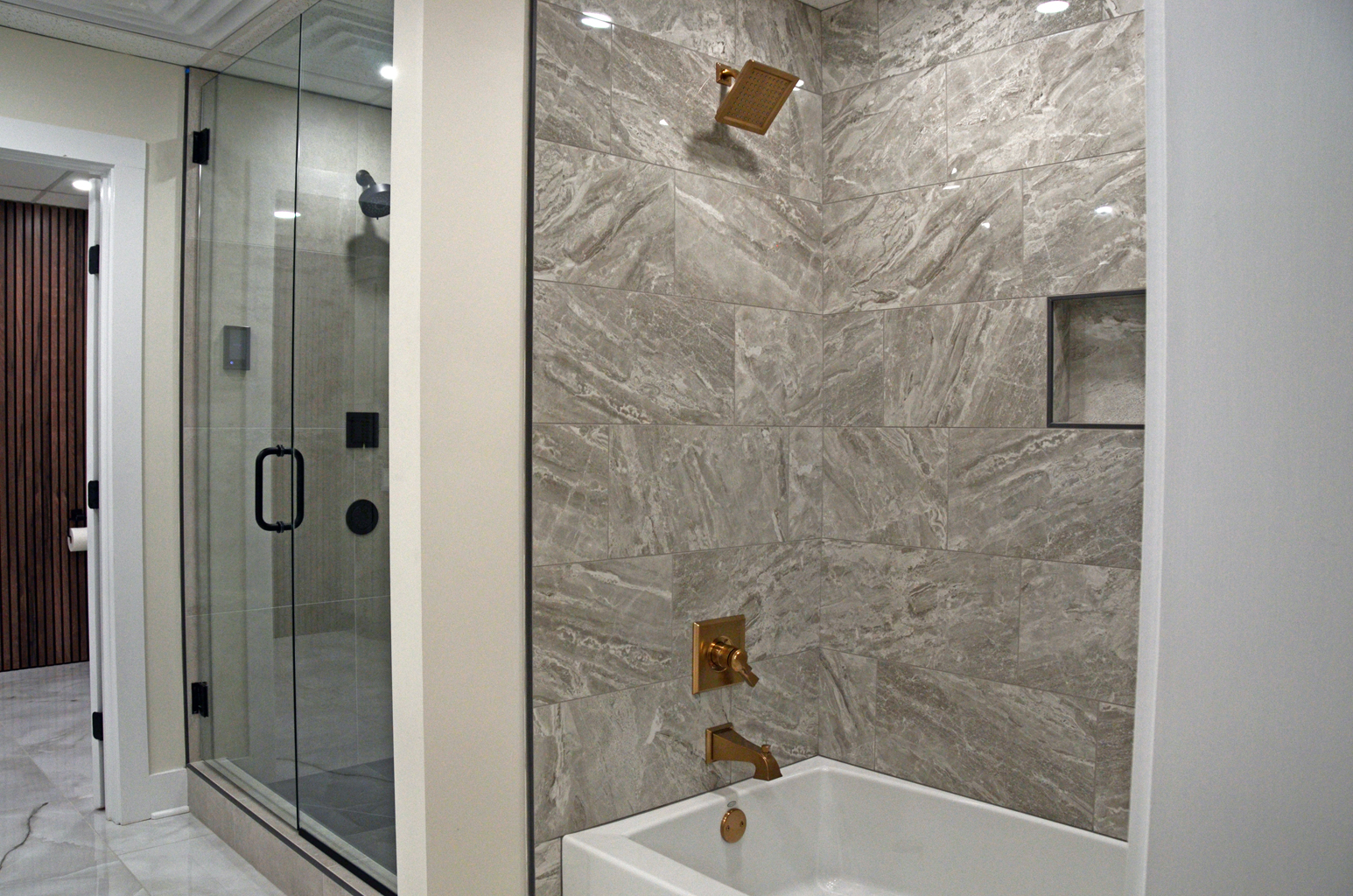 Bathroom Remodeling image by Guthrie Kitchen & Bath Plus Tiled walk-in shower display at the Guthrie Kitchen & Bath Plus showroom