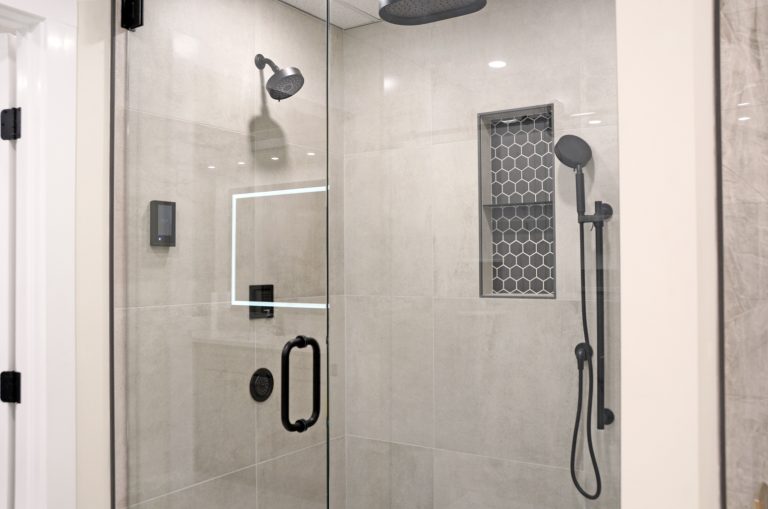 Tiled walk-in shower display at the Guthrie Kitchen & Bath Plus showroom