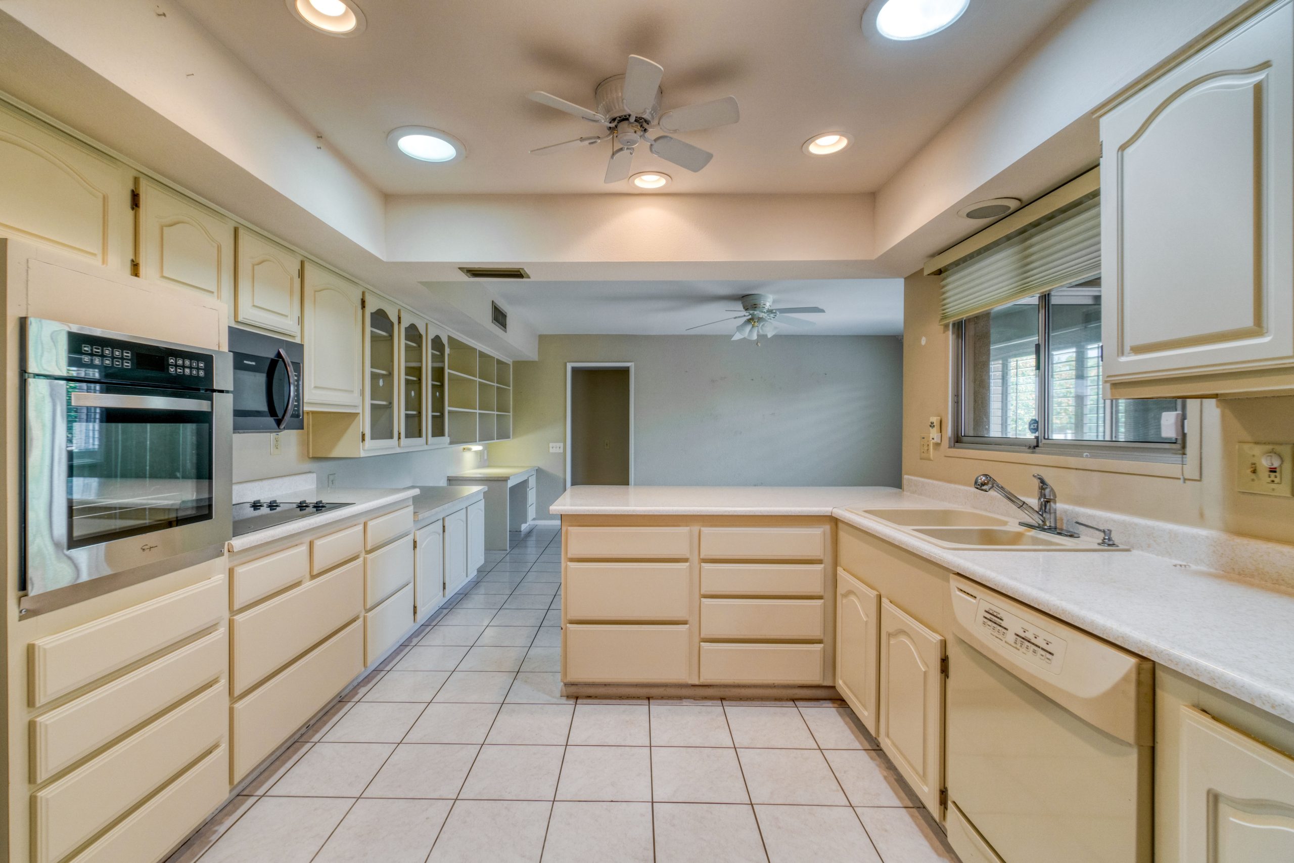 Dated kitchen with a boxed soffit above the wall cabinets and an HVAC register set into the soffit face