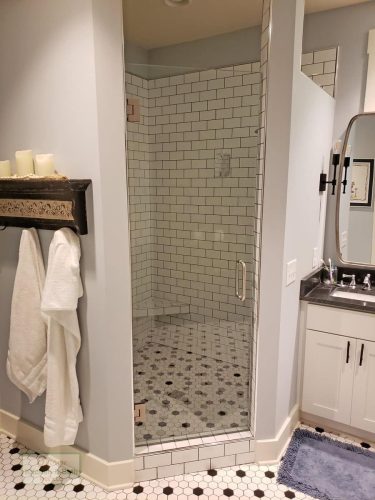 shower with subway tile wall