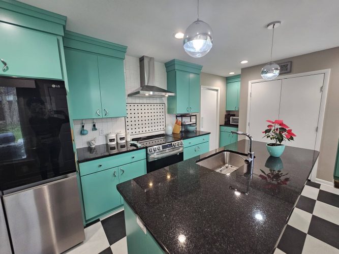 Completed turquoise kitchen with black countertops and checkerboard tile floor by Guthrie Kitchen & Bath